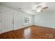 A view of a bedroom with neutral paint, wood flooring and a ceiling fan at 3320 Alderknoll Ct, Charlotte, NC 28216