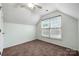Cozy carpeted bedroom featuring a large window and ceiling fan at 3320 Alderknoll Ct, Charlotte, NC 28216