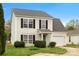 Charming two-story home with black shutters, a green front door, and an attached one-car garage at 3320 Alderknoll Ct, Charlotte, NC 28216