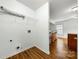 A simple laundry room with wood flooring and utility connections at 3320 Alderknoll Ct, Charlotte, NC 28216