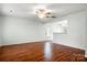 A view of a living room with neutral paint, wood flooring and an open wall to the kitchen at 3320 Alderknoll Ct, Charlotte, NC 28216