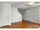 A view of a living room with neutral paint, wood flooring and a stairway at 3320 Alderknoll Ct, Charlotte, NC 28216
