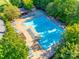 Aerial shot of a large community pool with ample lounge chairs and surrounding trees, perfect for summer relaxation at 3383 Norwich Rd, Fort Mill, SC 29715