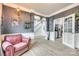 Cozy living room with elegant wallpaper, a doorway to the staircase, and a comfortable pink armchair at 3383 Norwich Rd, Fort Mill, SC 29715