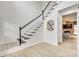 Beautiful staircase with black and white banister leading to the upper level with light hardwood floors at 3383 Norwich Rd, Fort Mill, SC 29715