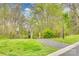 Scenic community walking trail leading to a charming wooden bridge, surrounded by lush greenery at 3383 Norwich Rd, Fort Mill, SC 29715