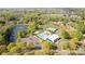 A lovely aerial view showcasing a community pool, tennis courts, pond and surrounding lush greenery and residential homes at 3411 Xandra Ct, Indian Land, SC 29707