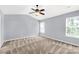 Large bedroom with fan, plush carpet, and window for natural light at 3411 Xandra Ct, Indian Land, SC 29707