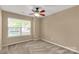 Bedroom featuring neutral walls, carpet, ceiling fan, and a large window allowing natural light at 3411 Xandra Ct, Indian Land, SC 29707