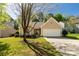 Charming single-story home with a two-car garage, well-manicured lawn and mature tree shading the front yard at 3411 Xandra Ct, Indian Land, SC 29707