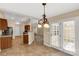 The cozy kitchen features tile floors, wood cabinets, and a vintage hanging light fixture at 3411 Xandra Ct, Indian Land, SC 29707