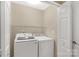 Functional laundry room features new machines, storage shelf, and interior door at 3411 Xandra Ct, Indian Land, SC 29707