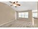 Neutral living area with a ceiling fan, large windows, and ample natural light at 3411 Xandra Ct, Indian Land, SC 29707