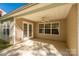 Covered patio featuring a ceiling fan and view through the glass doors and windows into the backyard at 3411 Xandra Ct, Indian Land, SC 29707