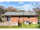 Back view of a brick house with a concrete patio and a fenced yard at 394 Efird St, Gastonia, NC 28054