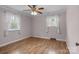 The sunny bedroom offers two windows and wood-look flooring at 394 Efird St, Gastonia, NC 28054