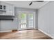 Cozy dining area with light-colored walls, a ceiling fan, and access to the back patio at 394 Efird St, Gastonia, NC 28054
