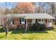 Charming brick ranch home featuring a well-maintained lawn, and cozy front porch at 394 Efird St, Gastonia, NC 28054