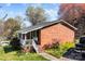 Lovely brick home with a covered front porch and walkway, surrounded by greenery, set for comfortable living at 394 Efird St, Gastonia, NC 28054