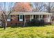 Well maintained red brick home with a cozy front porch and manicured landscaping, offering classic charm at 394 Efird St, Gastonia, NC 28054