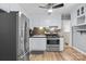 An efficient kitchen shows white cabinets, stainless appliances and wood-look flooring at 394 Efird St, Gastonia, NC 28054