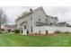 Well-manicured lawn and white fencing create a serene and private backyard retreat at 4130 Town Center Rd, Harrisburg, NC 28075