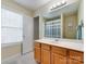 Bright bathroom with a window, spacious vanity, and a full-sized mirror at 4130 Town Center Rd, Harrisburg, NC 28075