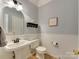 Powder room with white wainscotting and pedestal sink at 4130 Town Center Rd, Harrisburg, NC 28075