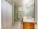Cozy bathroom features a shower-tub combo and a light wood vanity with a bright mirror at 4130 Town Center Rd, Harrisburg, NC 28075