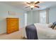 Well-lit bedroom features a ceiling fan, neutral carpet, and coordinating furnishings at 4130 Town Center Rd, Harrisburg, NC 28075