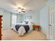 Comfortable bedroom with a ceiling fan, plush carpet, and a queen bed at 4130 Town Center Rd, Harrisburg, NC 28075