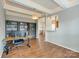 Bonus room with laminate floors, a desk, and bookcases at 4130 Town Center Rd, Harrisburg, NC 28075
