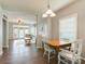 The open-concept dining room boasts hardwood floors, neutral walls, natural light, and view to the living room at 4130 Town Center Rd, Harrisburg, NC 28075