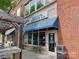 Street view of Rocky River Coffee Co. in a charming brick building with outdoor seating at 4130 Town Center Rd, Harrisburg, NC 28075