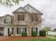 Charming two-story home with manicured lawn and updated siding details at 4130 Town Center Rd, Harrisburg, NC 28075