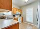 Kitchen features wood cabinets, white appliances, and a window to provide natural light at 4130 Town Center Rd, Harrisburg, NC 28075