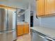 Spacious kitchen with stainless steel fridge and a peek into a bonus room at 4130 Town Center Rd, Harrisburg, NC 28075