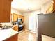 Well-lit kitchen featuring stainless steel appliances, tiled floor, and light wood cabinets at 4130 Town Center Rd, Harrisburg, NC 28075