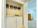 A practical laundry closet offers storage shelves and a modern washer and dryer at 4130 Town Center Rd, Harrisburg, NC 28075