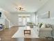 Bright living room features hardwood floors, neutral walls, a ceiling fan and french doors to the backyard at 4130 Town Center Rd, Harrisburg, NC 28075