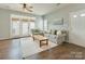 The cozy living room boasts hardwood floors, matching couches, and natural light from the French doors at 4130 Town Center Rd, Harrisburg, NC 28075