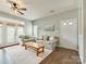 Sunlit living room boasts hardwood floors, neutral decor, and a ceiling fan at 4130 Town Center Rd, Harrisburg, NC 28075