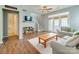 Bright living room features hardwood floors, neutral walls, a ceiling fan and french doors to the backyard at 4130 Town Center Rd, Harrisburg, NC 28075