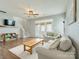 Bright living room features hardwood floors, neutral walls, a ceiling fan and french doors to the backyard at 4130 Town Center Rd, Harrisburg, NC 28075
