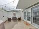 Enjoy outdoor living on this private patio with stylish wicker furniture and string lights at 4130 Town Center Rd, Harrisburg, NC 28075