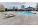 The community pool with sun loungers has a clubhouse in the background at 4130 Town Center Rd, Harrisburg, NC 28075