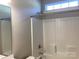 Bright bathroom features a shower with white tiled walls and modern fixtures at 5126 Rocky River Crossing Rd, Harrisburg, NC 28075