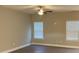 Bright bedroom with ceiling fan, two windows, and neutral paint at 5126 Rocky River Crossing Rd, Harrisburg, NC 28075