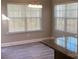 Dining area with modern chandelier and large windows offering natural light and views at 5126 Rocky River Crossing Rd, Harrisburg, NC 28075