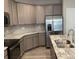 Modern kitchen features stainless steel appliances, granite countertops, and gray cabinets at 5126 Rocky River Crossing Rd, Harrisburg, NC 28075